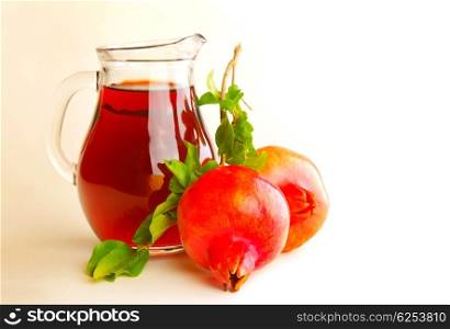 Pomegranate juice in a jug isolated on white