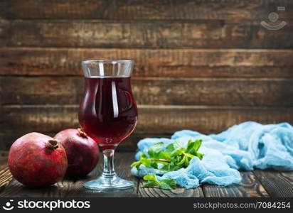 pomegranate juice in glass and on a table