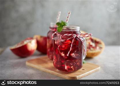 Pomegranate juice in jar with handle.