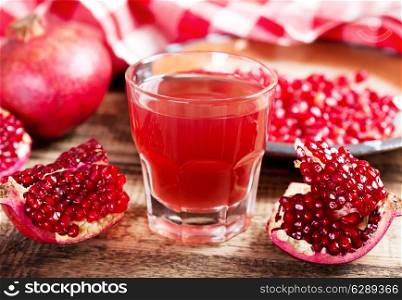 pomegranate juice with fresh fruits on wooden table
