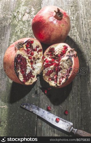 Pomegranate on vintage wooden table.
