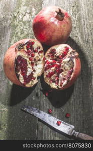 Pomegranate on vintage wooden table.