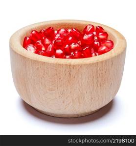 Pomegranate seeds in wooden bowl close-up macro studio shot. Pomegranate seeds in wooden bowl close-up