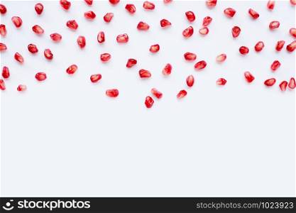Pomegranate seeds on white background. Copy space