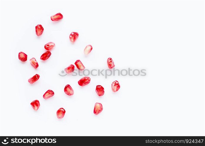 Pomegranate seeds on white background. Copy space