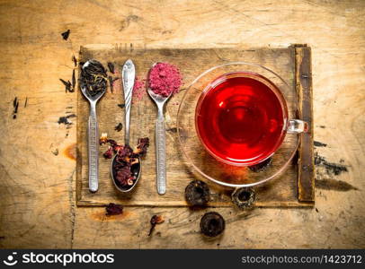 Pomegranate tea on the old Board. On wooden background.. Pomegranate tea on the old Board.