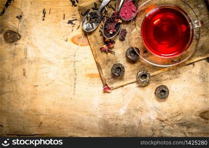 Pomegranate tea on the old Board. On wooden background.. Pomegranate tea on the old Board.