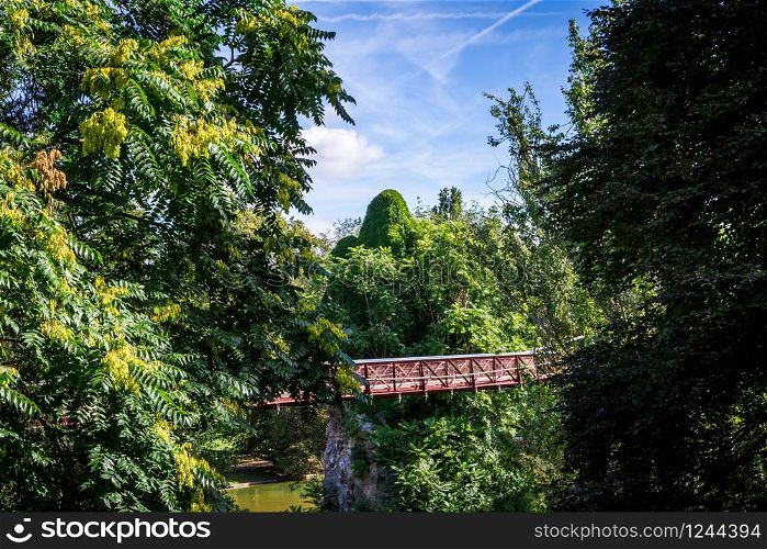 Pond and bridge in Buttes-Chaumont Park in summer, Paris. Pond in Buttes-Chaumont Park, Paris