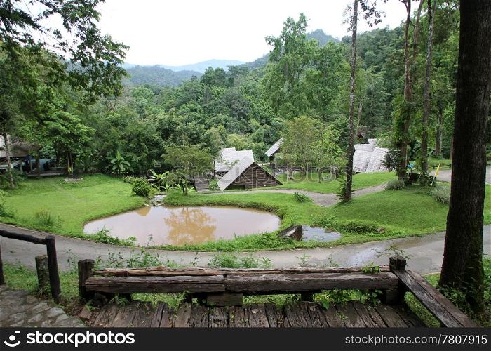 Pond and houses in the national park Pongduet in Northern Thailand