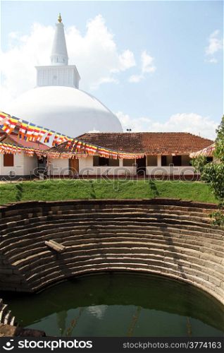 Pond and white stupa in buddhist monastery in Anuradhapura, Sri Lanka
