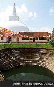 Pond and white stupa in buddhist monastery in Anuradhapura, Sri Lanka