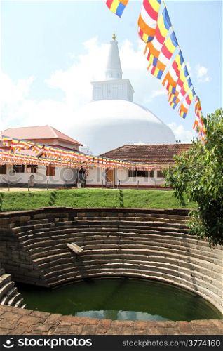 Pond and white stupa in buddhist monstery in Anuradhapura, Sri Lanka