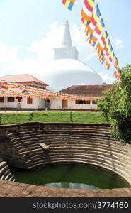 Pond and white stupa in buddhist monstery in Anuradhapura, Sri Lanka