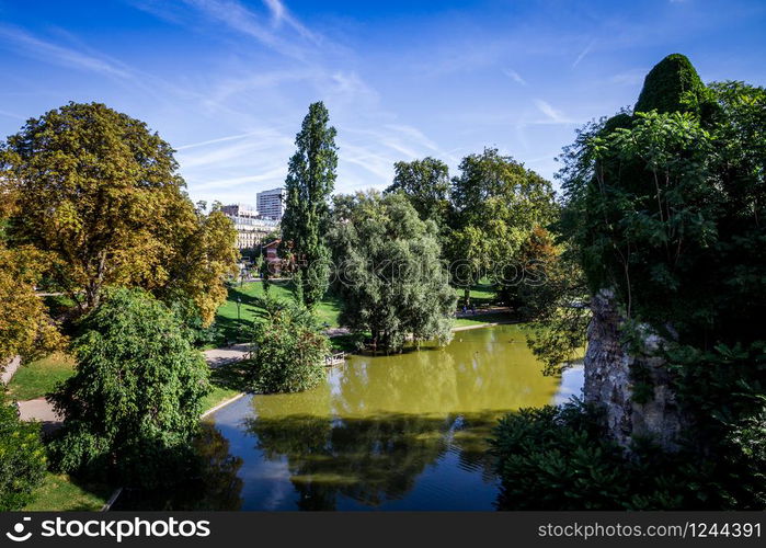 Pond in Buttes-Chaumont Park in summer, Paris. Pond in Buttes-Chaumont Park, Paris