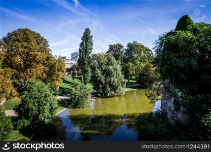 Pond in Buttes-Chaumont Park in summer, Paris. Pond in Buttes-Chaumont Park, Paris