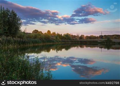 Pond in the countryside in autumn at sunset