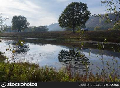 Pond in the countryside in autumn at sunset