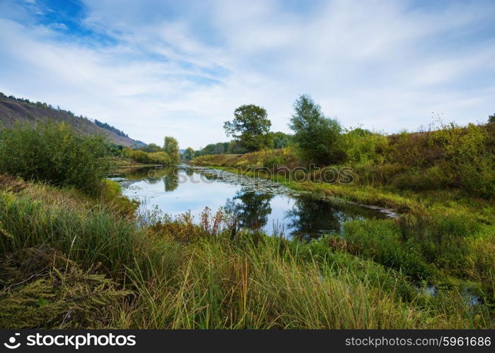 Pond in the countryside in autumn at sunset