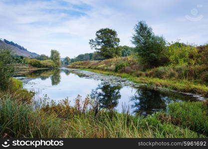 Pond in the countryside in autumn at sunset