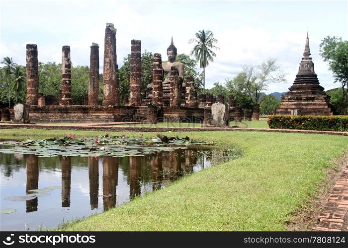 Pond with lotuses a nd ruins of wat Mahathat, Sukhotai, Thailand