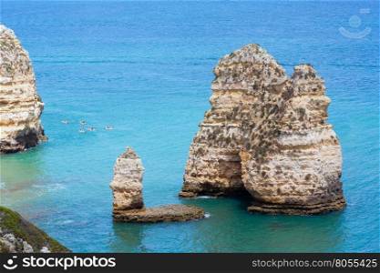 Ponta da Piedade (group of rock formations along coastline of Lagos town, Algarve, Portugal). People are unrecognizable.