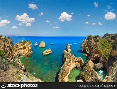Ponta da Piedade  group of rock formations along coastline of Lagos town, Algarve, Portugal . People on boats are unrecognizable.