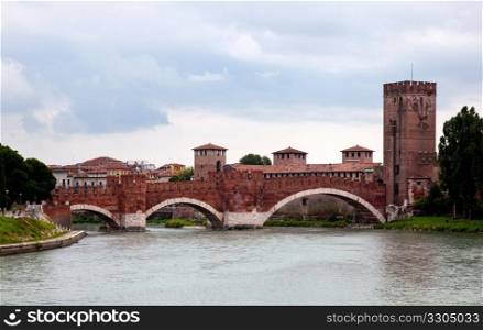 Ponte CastelVecchio in Verona with battlements against the cloudy sky