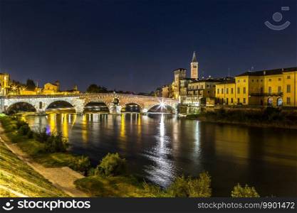 Ponte di Pietra. Bridge in Verona in a summer night, Italy,