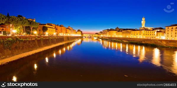 Ponte Vecchio bridge and Arno river waterfront in Florence evening view, Tuscany region of Italy