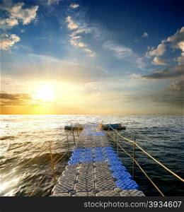 Pontoon with handrails in the sea at sunset
