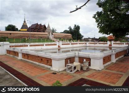 Pool and wat Phra That Lampang Luang