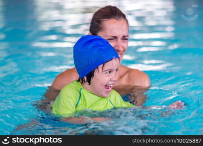 pool  class  boy  child  water  fun  little  swimming  activity  cute  blue  childhood  lesson  sport  male  happy  kid  learning  people  cap  swimmer  indoor  physical  young  play  lifestyle  teaching  leisure  swimwear  mother  family  photography  caucasian  healthy  action  indoors  splashing  sports  training  swimsuit  toddler  swim  positive  active  playing  children  exercise  splash  cheerful  recreational  recreation  playful  boys  swimming pool  water sport  swimming baby, swimming lessons, baby swim, swim, baby swimming pool 