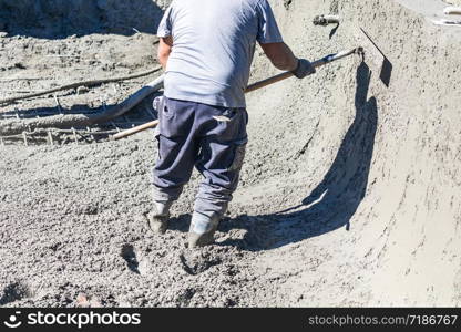 Pool Construction Worker Working With A Bullfloat On Wet Concrete