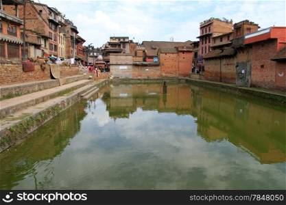 Pool with green water near houses in Bhaktapur in Nepal