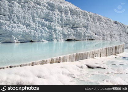 Pool with water and travertine formations in Pamukkale, Turkey