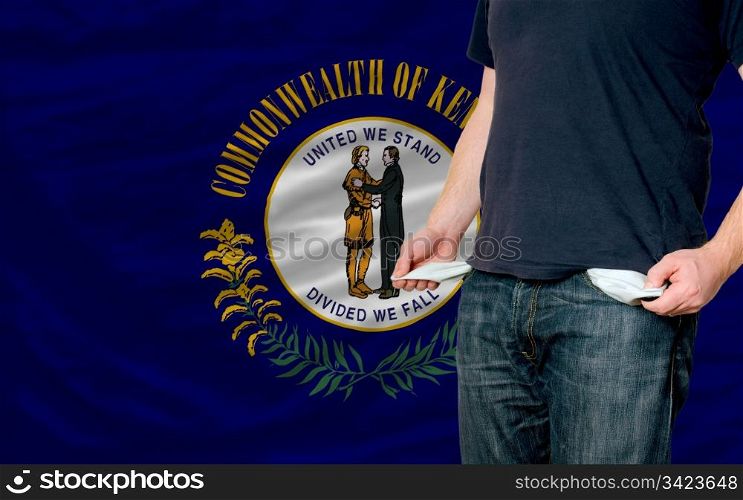 poor man showing empty pockets in front of american state of kentucky flag