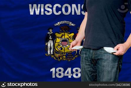 poor man showing empty pockets in front of american state of wisconsin flag