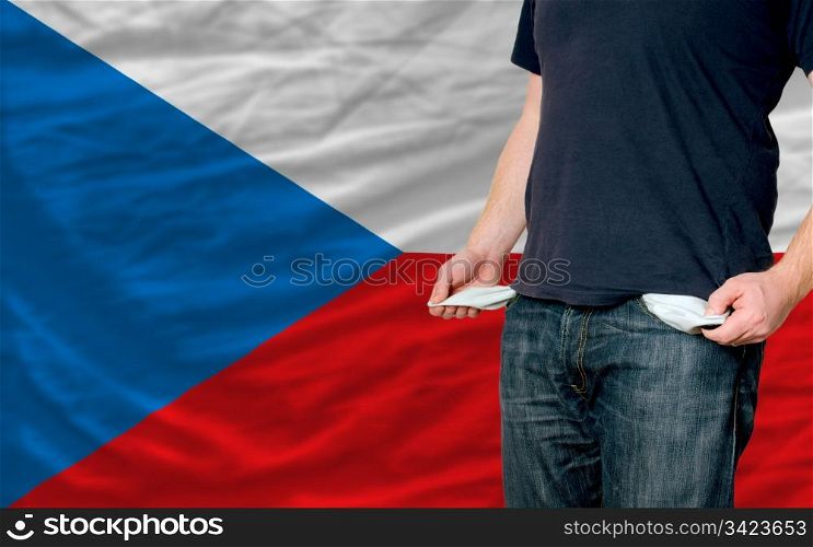 poor man showing empty pockets in front of czech flag