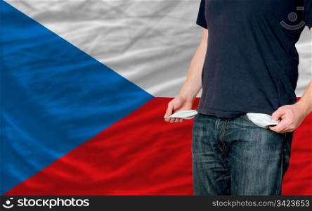 poor man showing empty pockets in front of czech flag