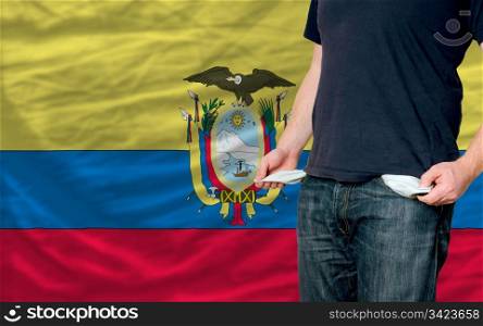 poor man showing empty pockets in front of ecuador flag