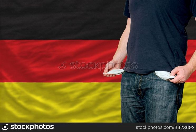 poor man showing empty pockets in front of germany flag