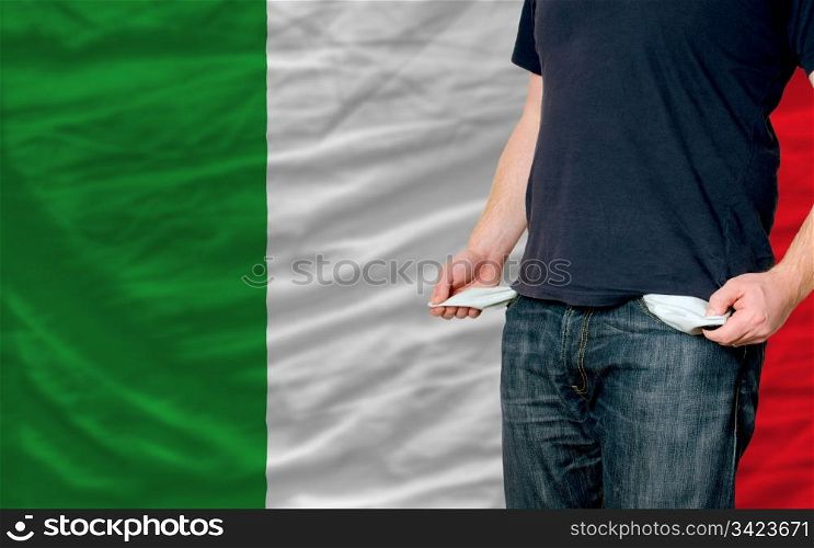poor man showing empty pockets in front of italy flag