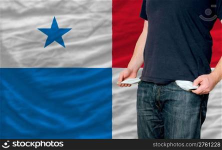 poor man showing empty pockets in front of panama flag