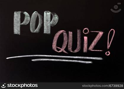 Pop quiz written in chalk on a blackboard