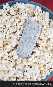 Popcorn and remote control prepared to see cinema