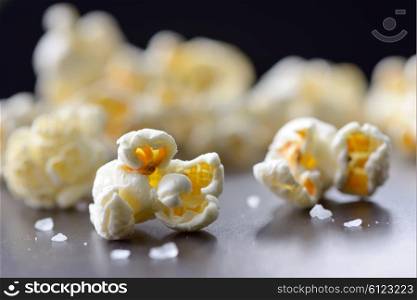Popcorn and salt isolated on black background
