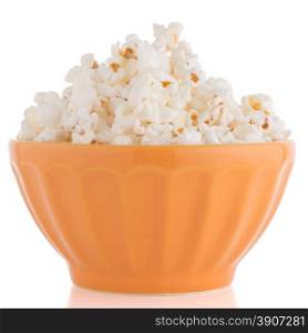 Popcorn in a orange bowl on a white background