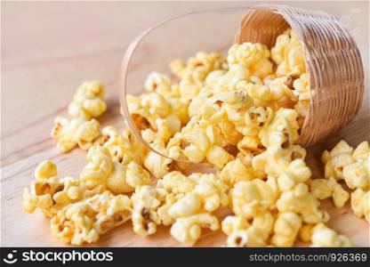 Popcorn in basket and wooden backgroubd / Sweet butter popcorn salt