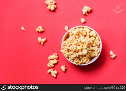 Popcorn in bucket on red background / Sweet butter popcorn salt