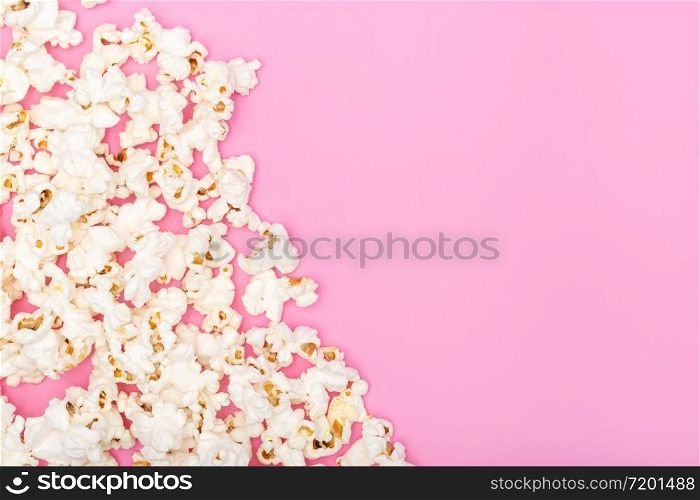 Popcorn on pink background. Movie or TV background, border, frame. Top view Copy space